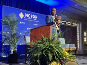 Speaker addressing audience at NCFOR conference on employee productivity